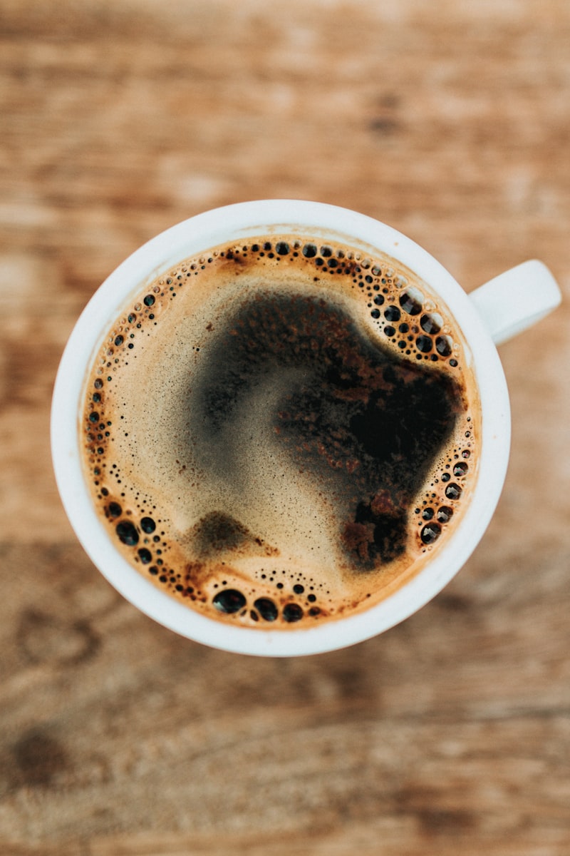 Artisan barista pouring silky milk foam into cup