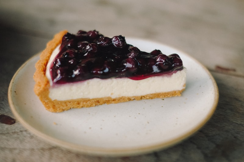 Freshly baked cheesecake topped with raspberries